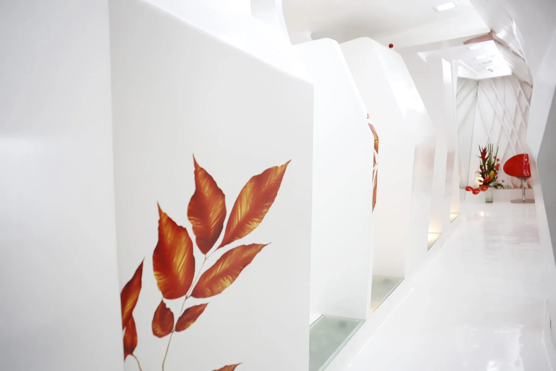 Corridor at Smiles By Dr. Cecile, Ayala Center, Makati, with the hand-painted backlit autumn-leaf panels leading to the treatment rooms